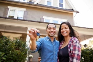 Couple holding up new house keys